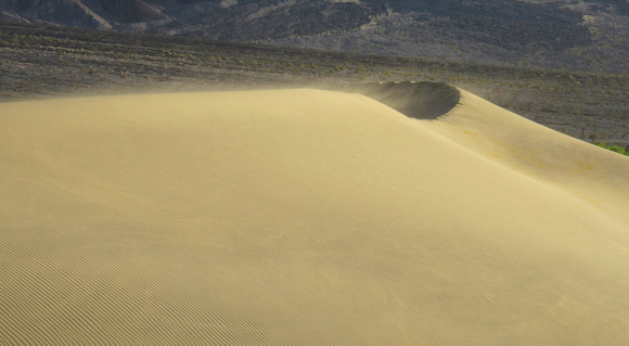 Winds carry sand across dunes